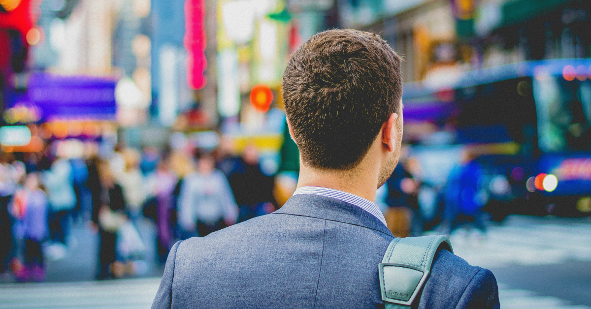 Young professional man walking around the city with his bag. 