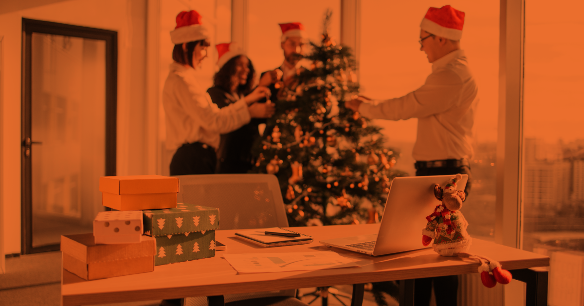 Team decorating the Christmas tree at work.