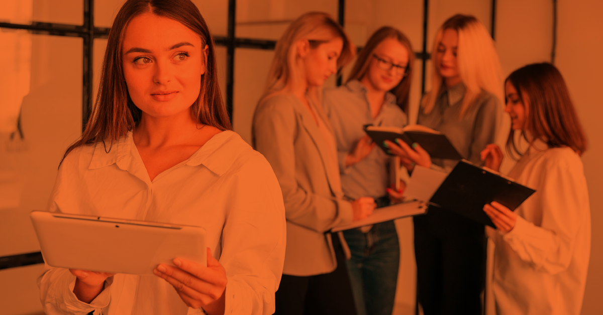Professional women collaborating in a modern office, representing women’s leadership, career growth and workplace inclusion.