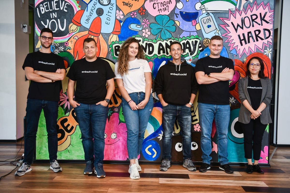 Gen Z employees standing in a modern workplace, representing young talent in Cyprus.