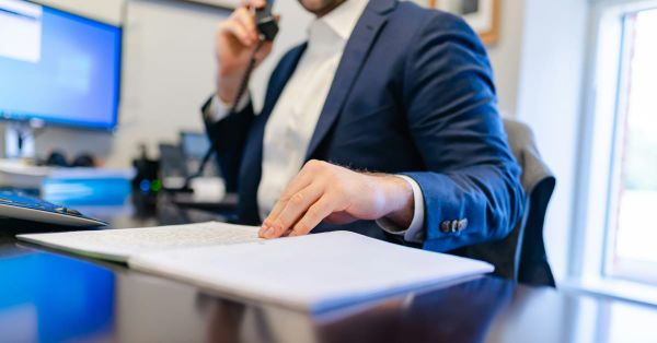 Professional going through notes on a desk.