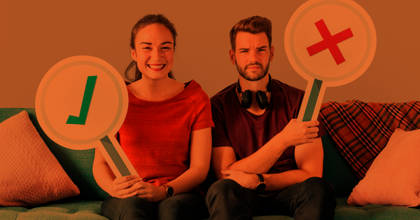 Girl holding a correct sign and young man holding a wrong sign. 