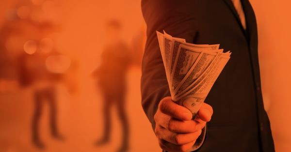 Professional man holding dollars 