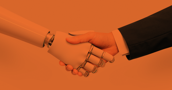 Human shaking hands with a robot.
