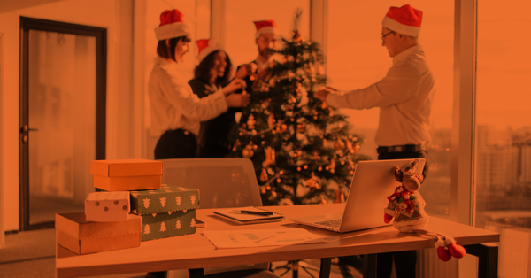 Team decorating the Christmas tree at work.