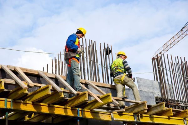 Construction workers working outdoors in Cyprus during summer heat, showing the impact of heatwaves on manual labour.