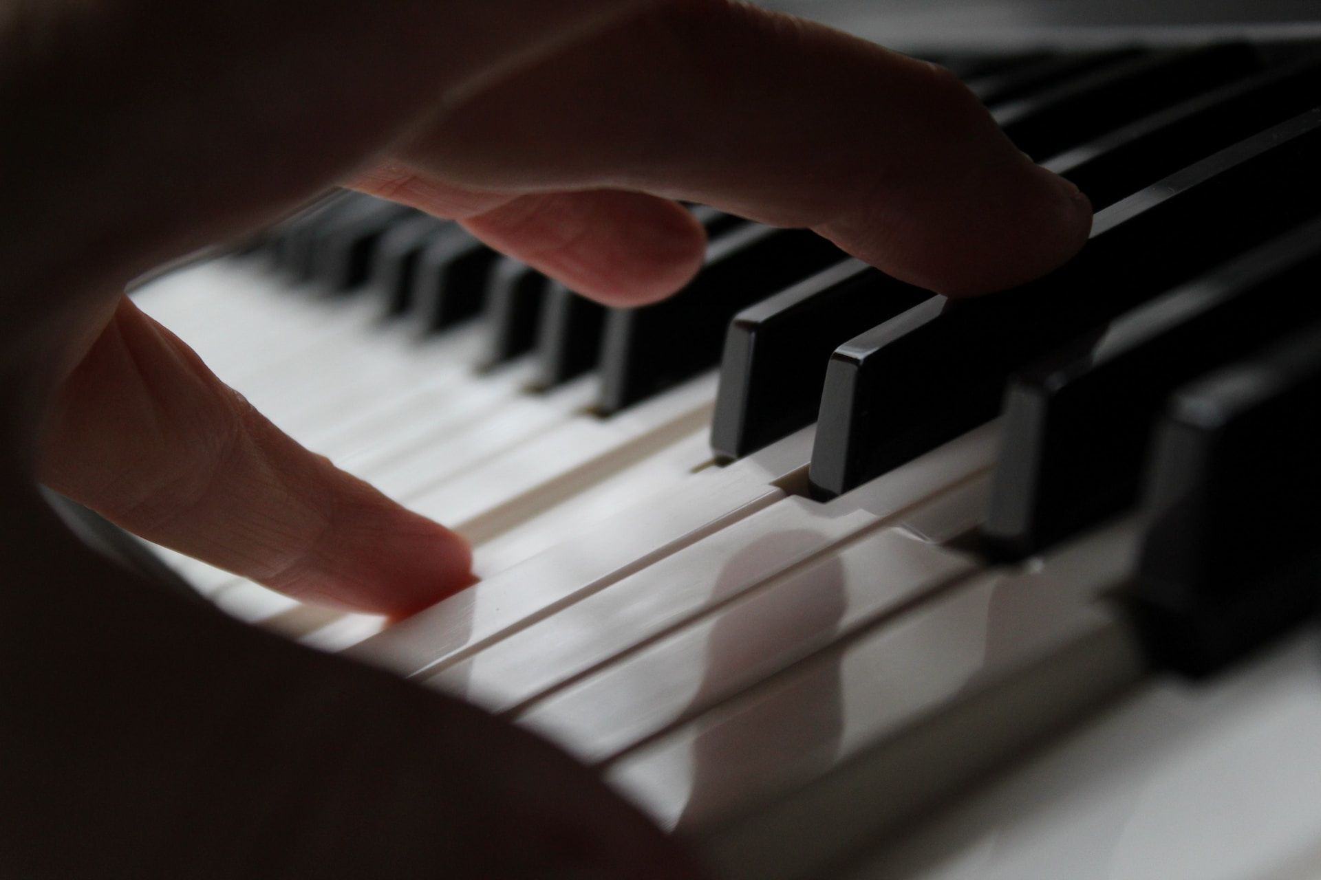 Finger pressing on a piano key