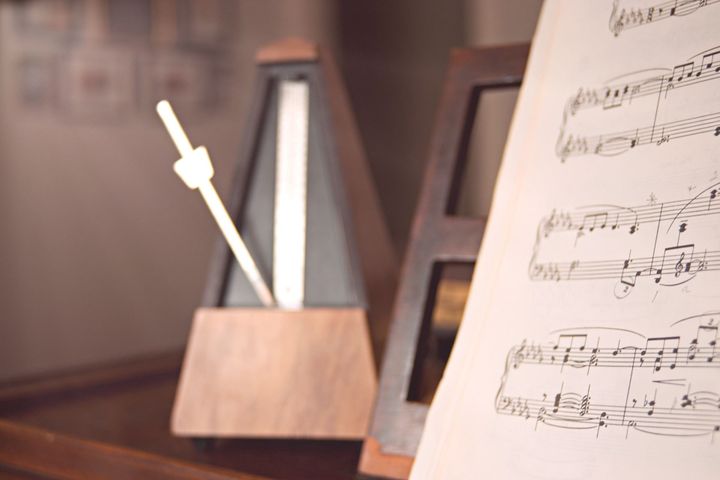A mechanical metronome alongside a piece of sheet music