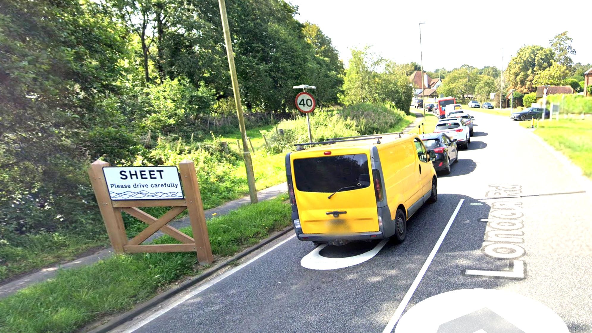 A screen grab from Google Maps showing the town sign for Sheet. Cars are stuck in traffic.