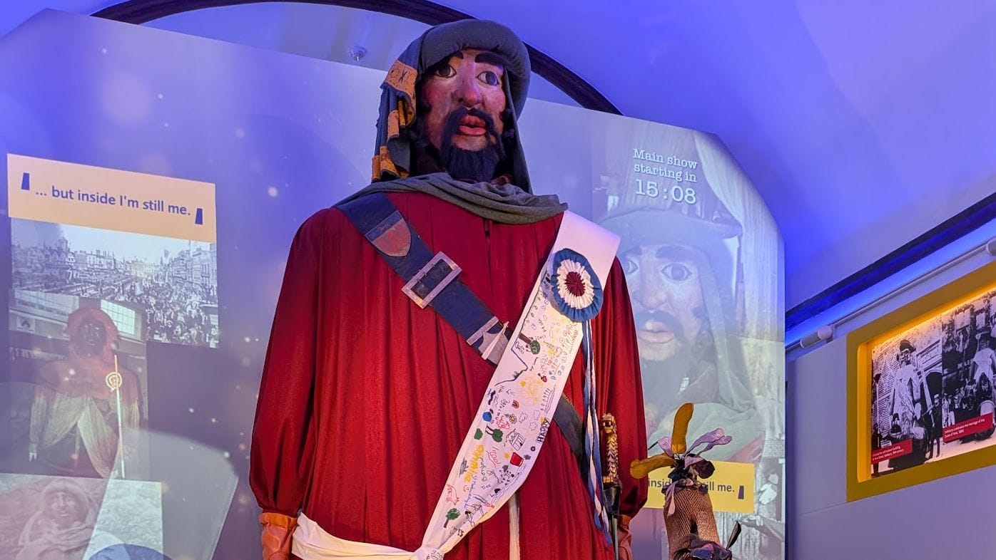 A massive statue of a giant wearing a red robe.