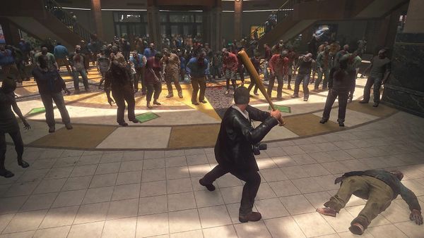 A man in a leather jacket hold up a baseball bat ready to defend himself against a horde of zombies inside a shopping mall.