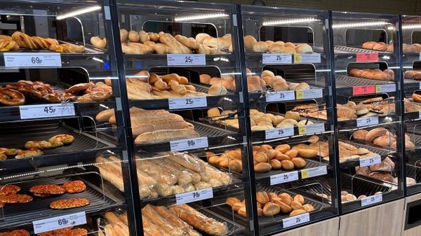 A photo of Lidl's bakery section, featuring rolls, pizza slices, cheese twists, and more.