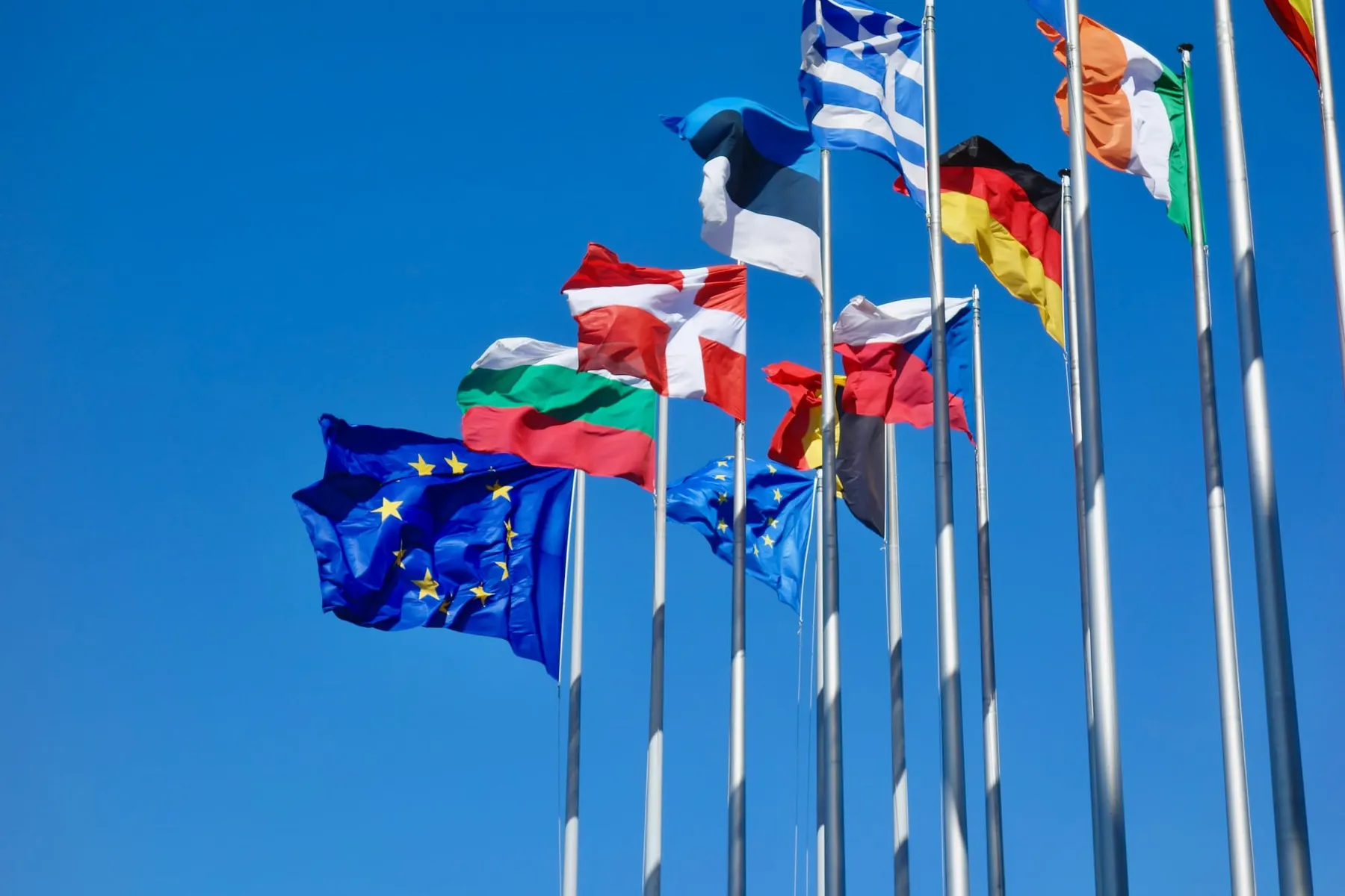 The EU flag amongst flags of member nations such as Germany and Greece.