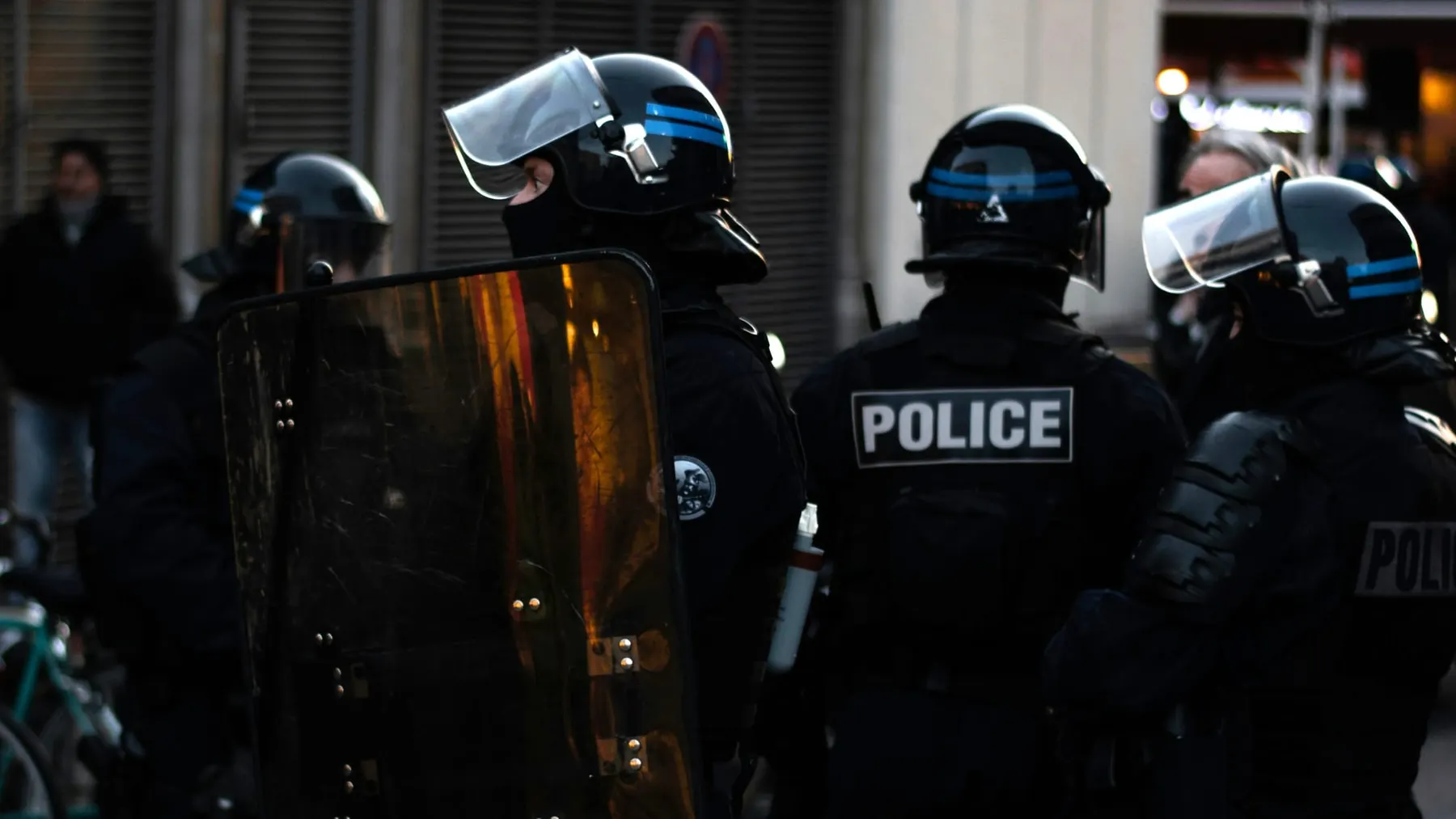 Riot police with helmets and large shields. The Turing Institute said UK police were not adequately equipped to deal with AI threats