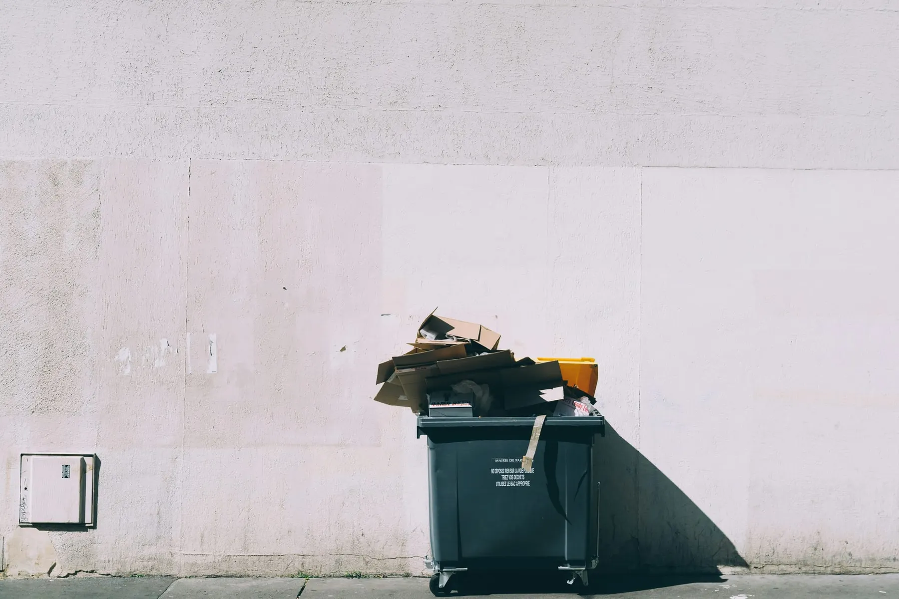 Rubbish overflowing out of a large bin on the street. Renesas has abandoned its SiC plans amid strong competition from China