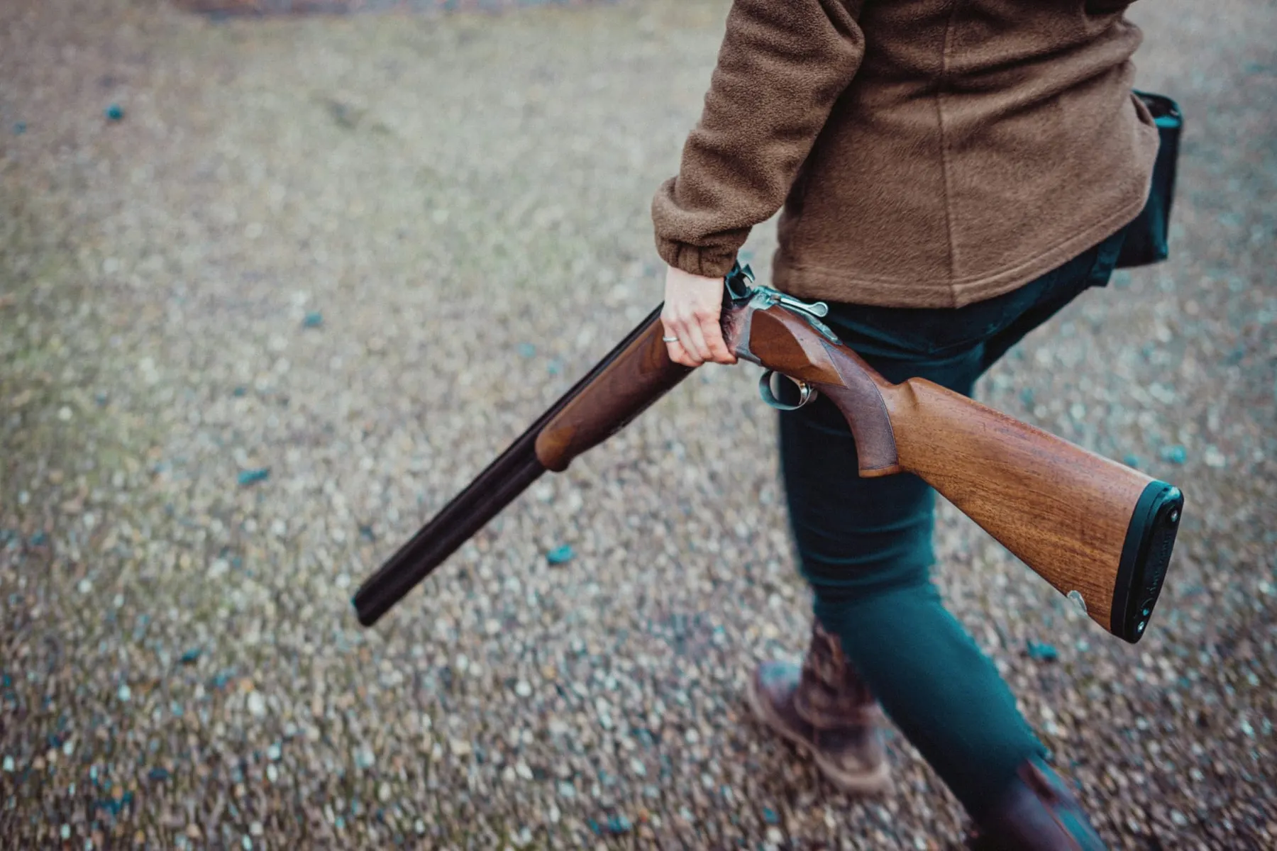 A person walks with a disarmed shotgun in their hand. The National Firearms Licensing Management System tracks all gun licenses in England and Wales