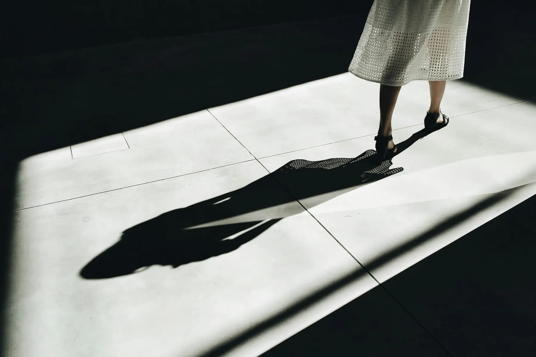A person walks away from the camera, their shadow can be seen framed by window light. Citrix Bleed 2 comes in the shadow of the original vulnerability from 2023.