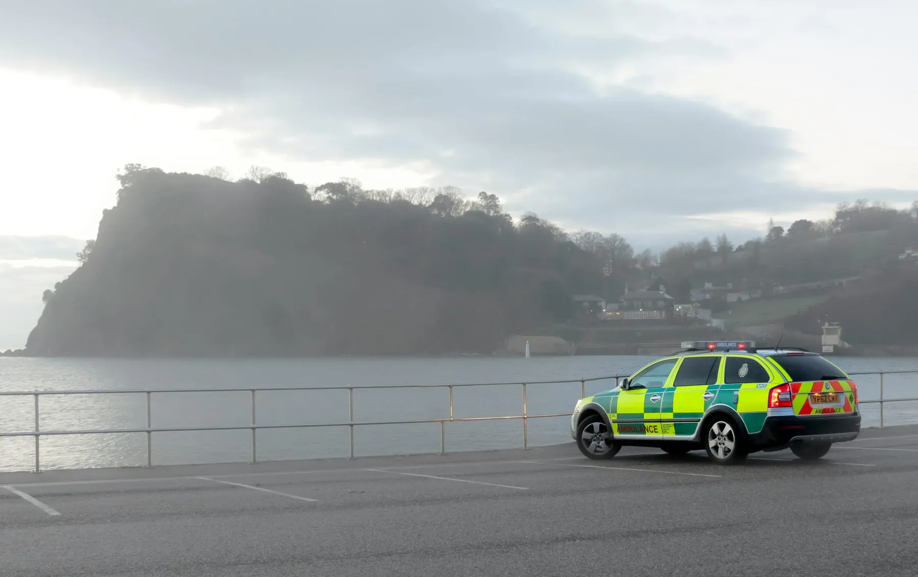 An ambulance vehicle parked by the sea.