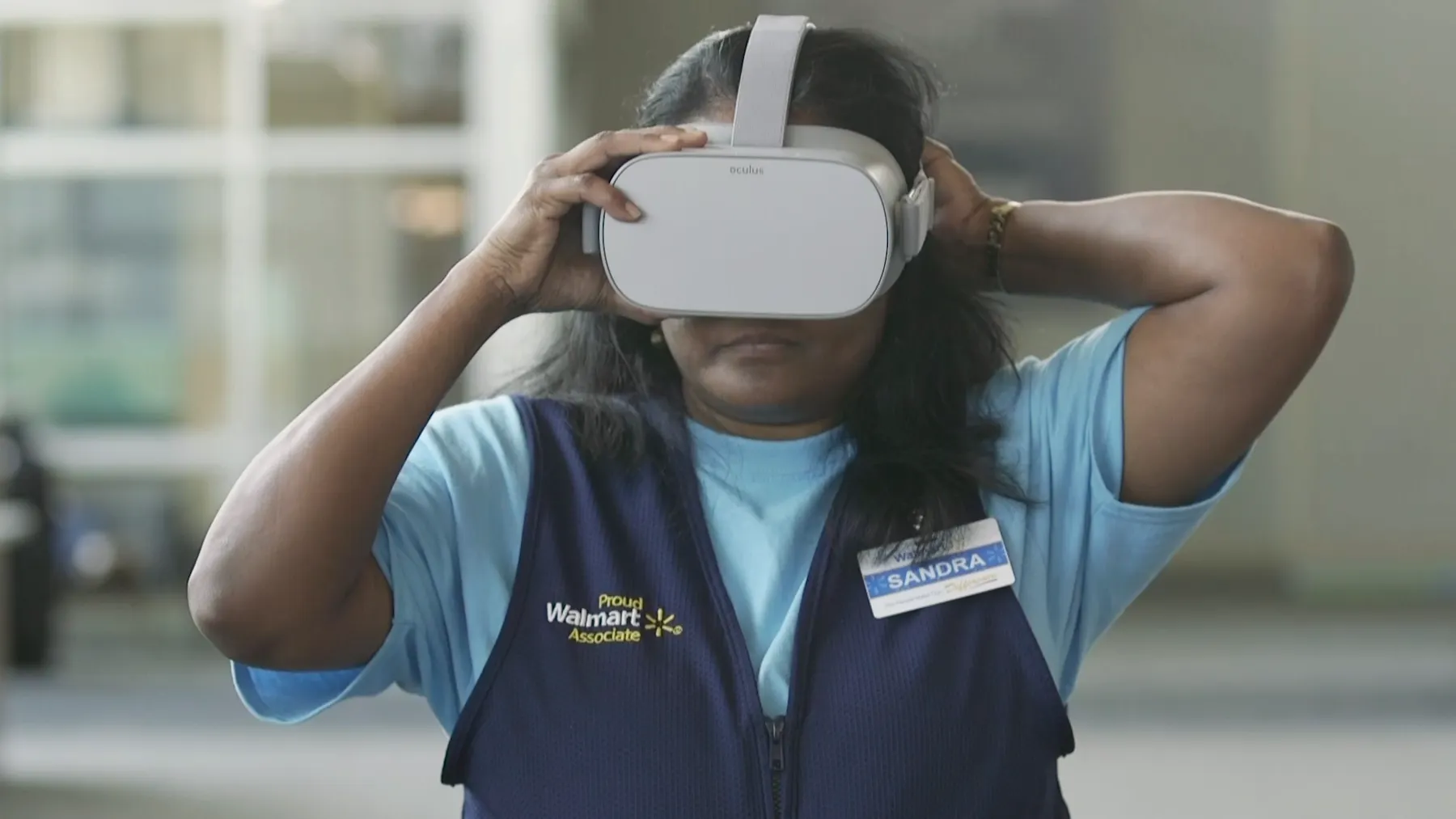A Walmart employee wearing an Oculus VR headset. Walmart is developing AI super agents.