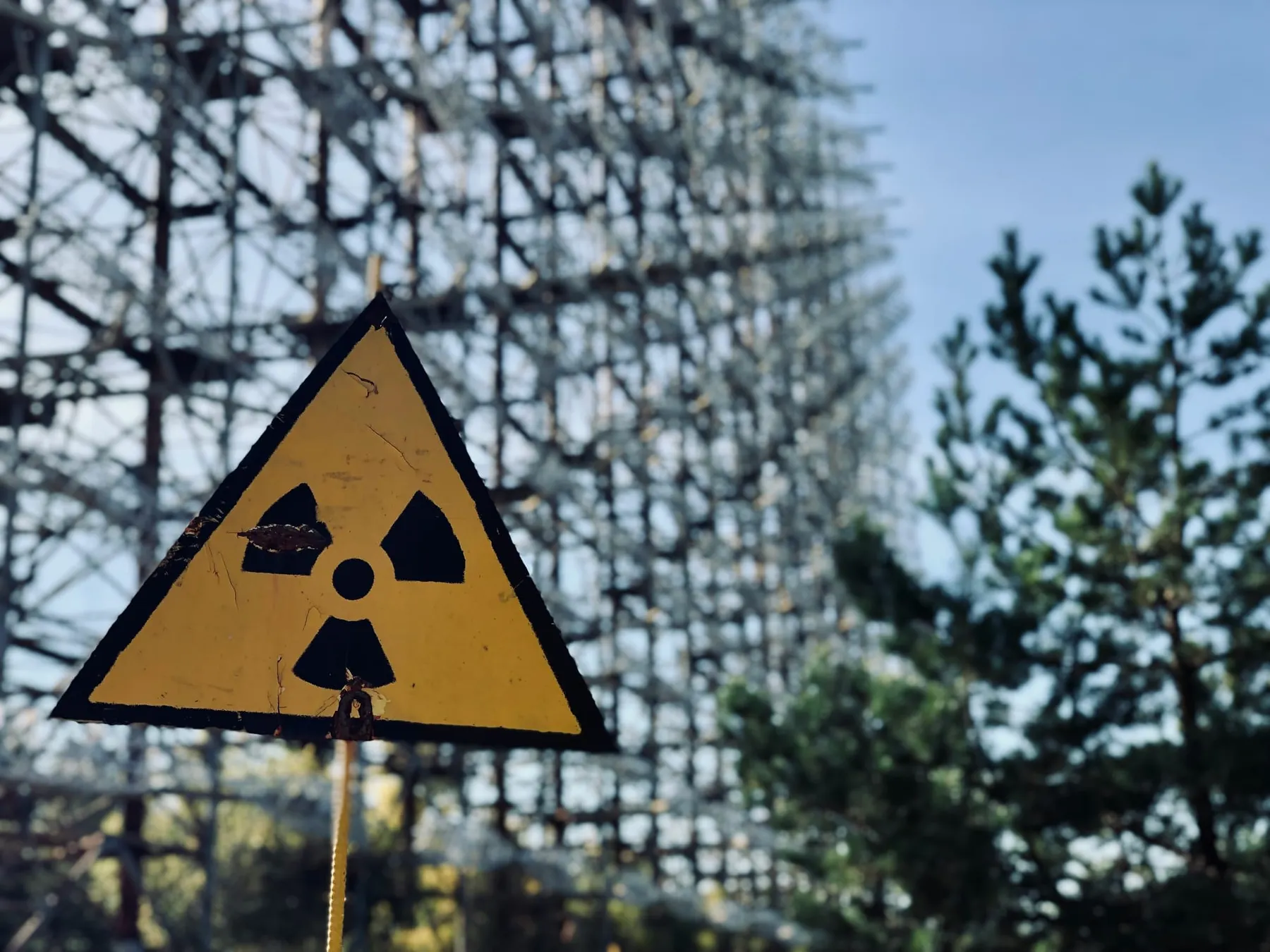 A nuclear warning sign in front of a large metal structure