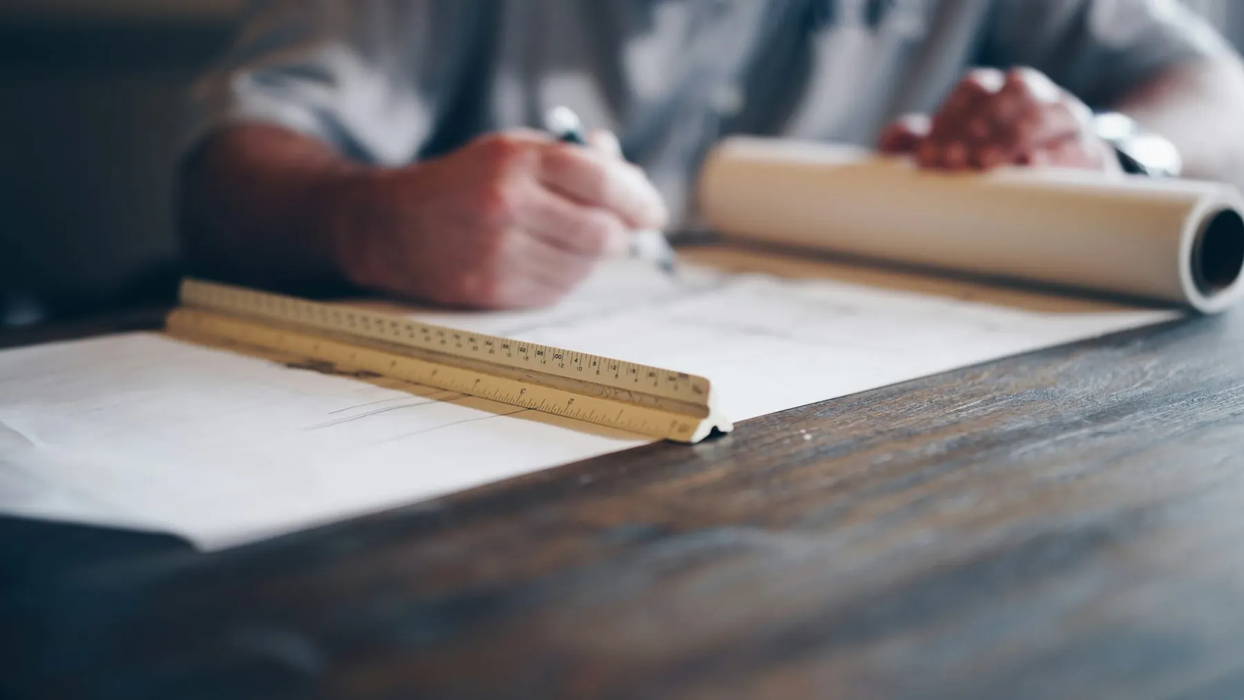 A person drawing up plans