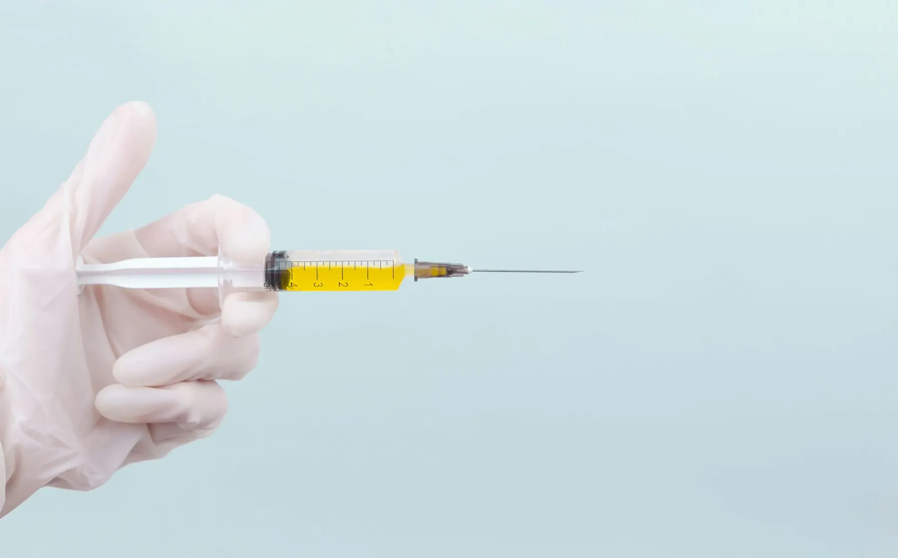 A syringe held in the air for an injection. The Python Software Foundation recieved a investment from Germany's Sovereign Tech Agency.