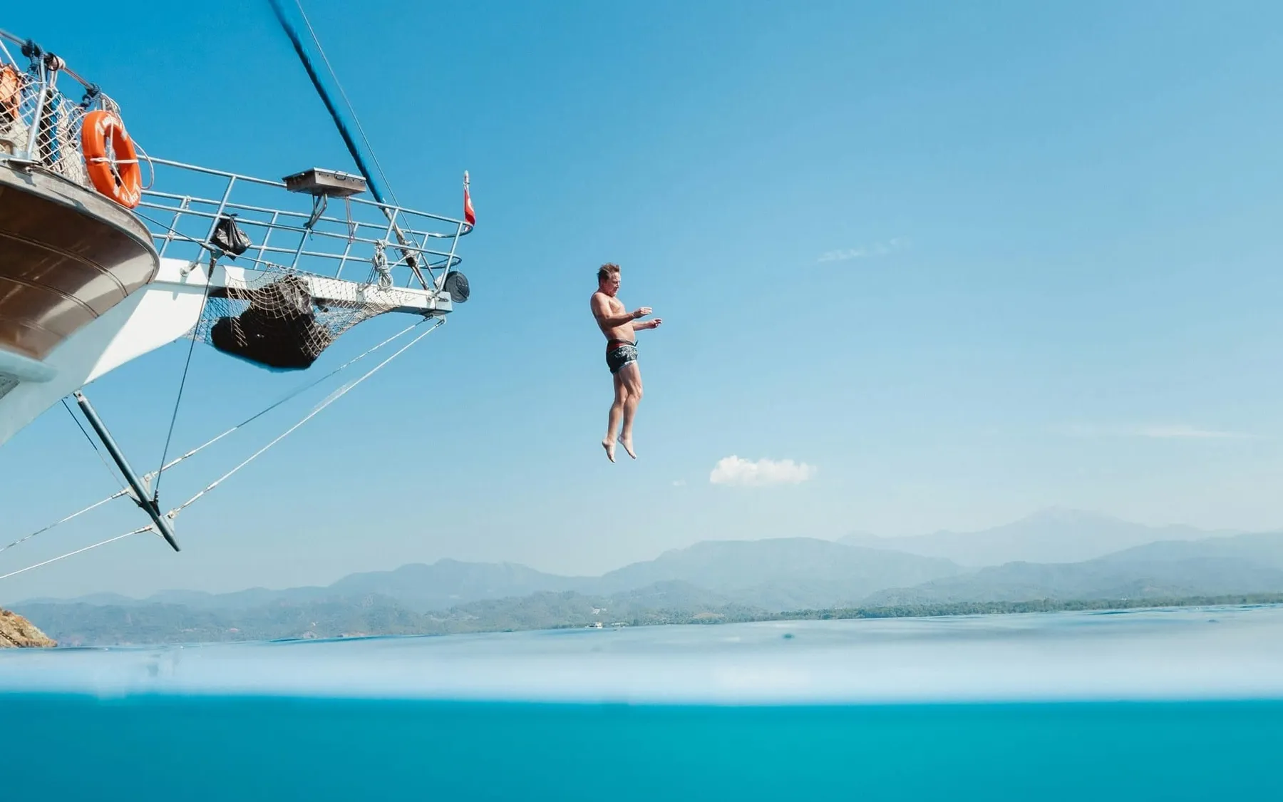 A man jumping into the water off a boat. Some users are leaving GitHub for opensource platforms.