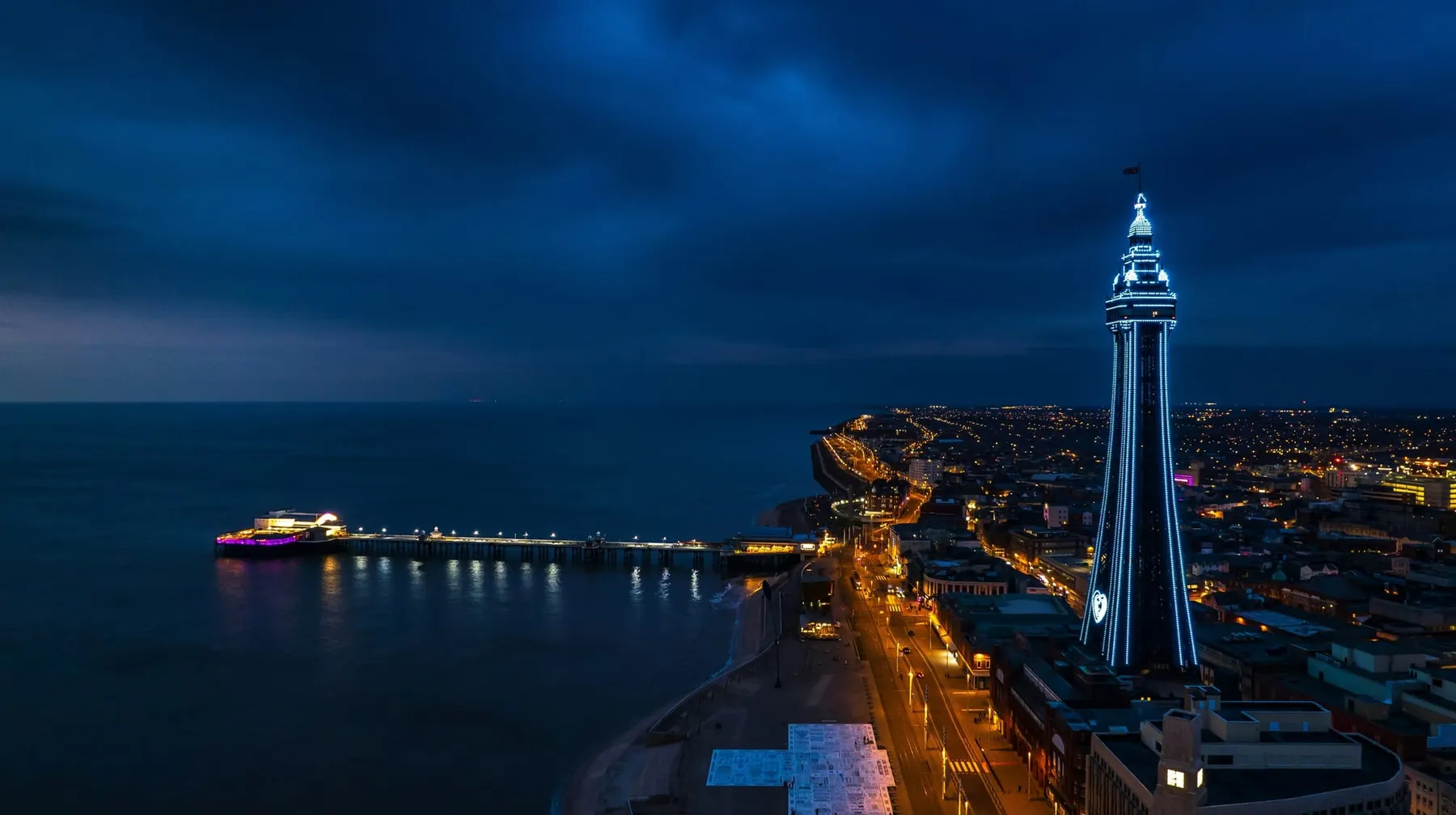 A view of Blackpool tower and pier at night.