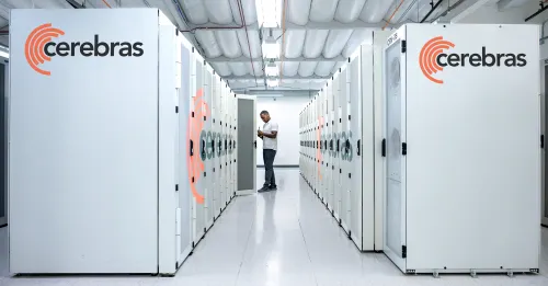 A data center worker examines a server cabinet designed by AI chip startup Cerebras.
