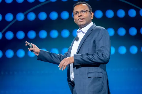 AWS's Swami Sivasubramanian speaks on stage at re:Invent 2024 wearing a dark blue blazer and white shirt.