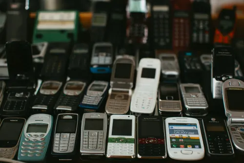 A pile of mobile phones to symbolise the use case of a SIM farm to manage multile SIM cards at once