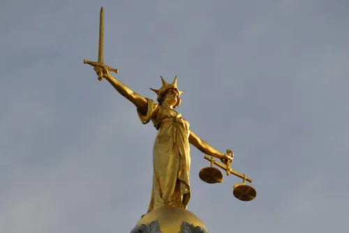 The Lady Justice Statue at the UK crown court, the Ministry of Justice's digital team combined networks for its court, probation and prison systems