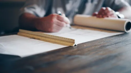 A person drawing up plans