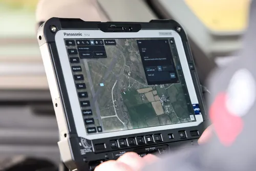 A military computer showing footage of a landscape from a drone