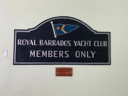 A sign on a wall that reads "Royal Barbados Yacht Club, Members Only."