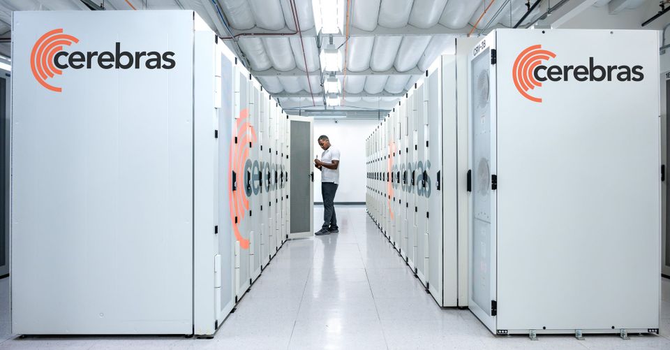A data center worker examines a server cabinet designed by AI chip startup Cerebras.