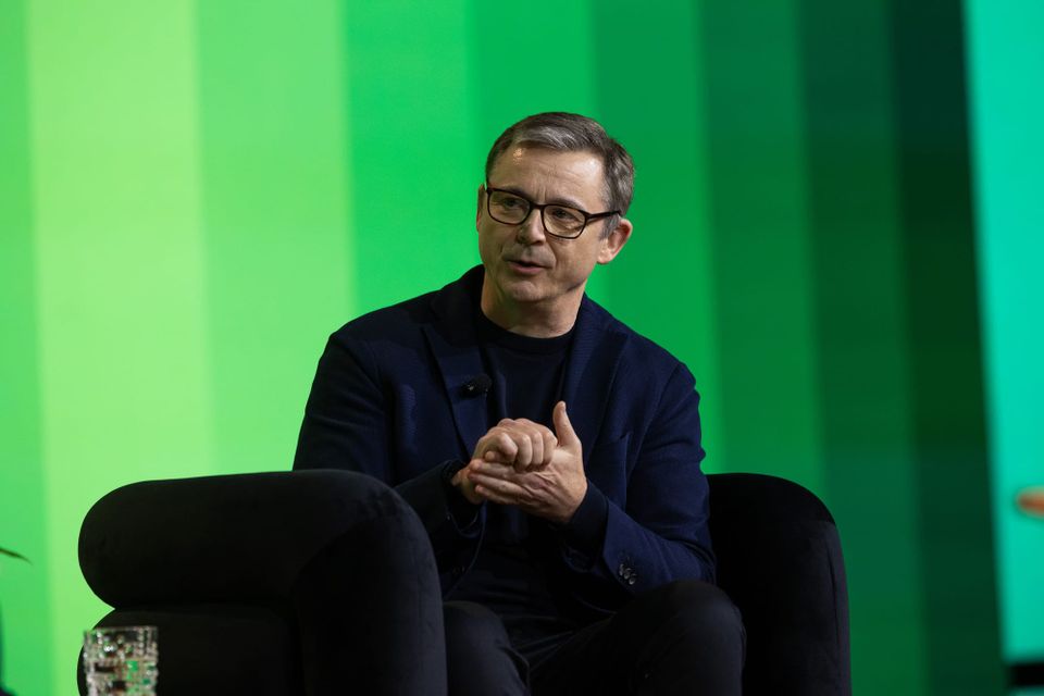 Adrian McDermott, CTO at Zendesk, sits at a chair in conversation