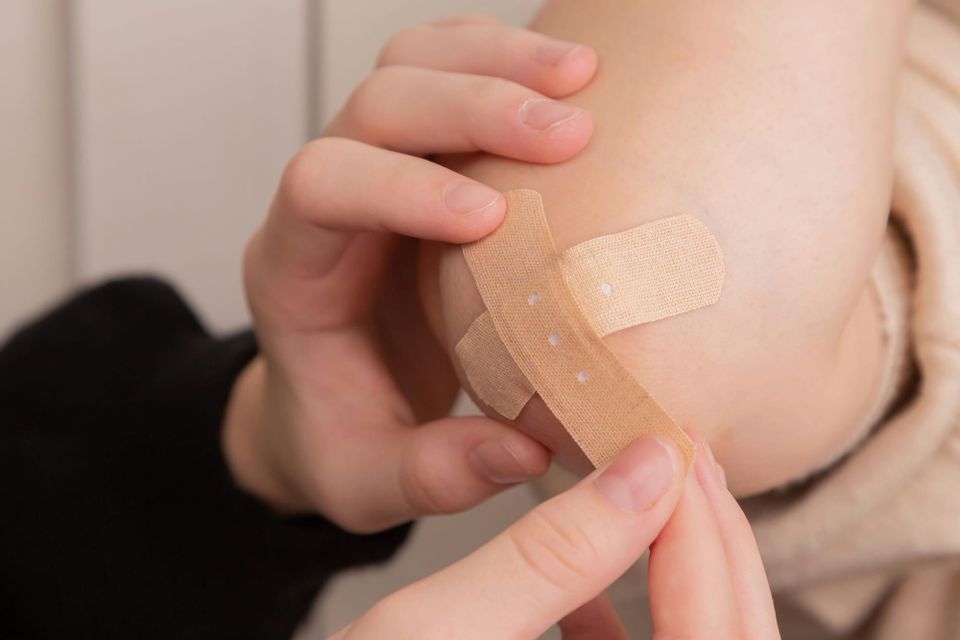 A person applies two plasters to an elbow. Veamm was criticised by security researchers for the patch used for its backup vulnerabilities