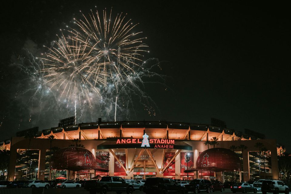 The LA Angels baseball stadium lit up at night with fireworks overhead