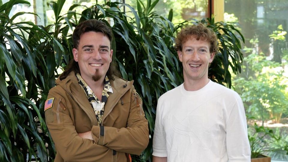 Palmer Luckey stands next to Mark Zuckerber