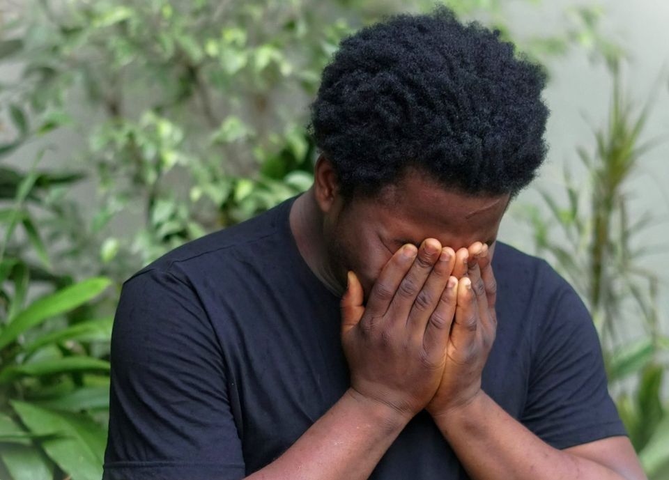 A man with his head in his hands. CISO burnout is a prevalent mental health issue in cybersecurity