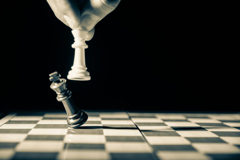 A white queen chess piece knocks over a black king piece. Google's search dominance could be curbed under new proposals from the UK competition and markets authorit