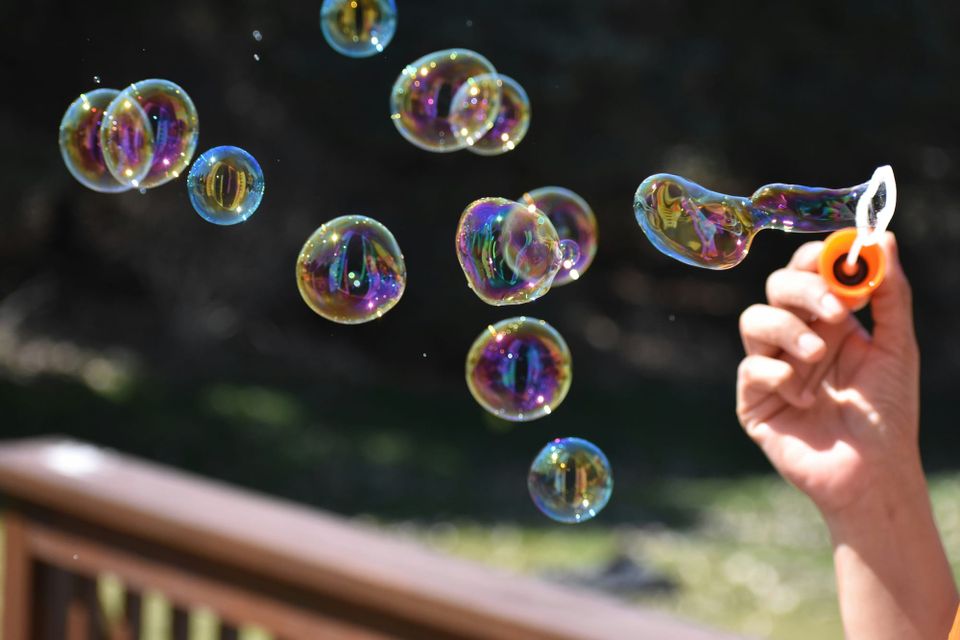 Someone blowing bubbles. Gartner said the agentic AI hype may be short-lived despite heavy investment as researchers find agents struggle with long-term tasks