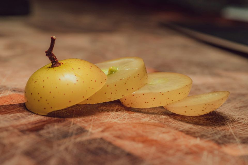 A sliced up muscadine fruit. OpenAI has slashed its AI model prices for developers 