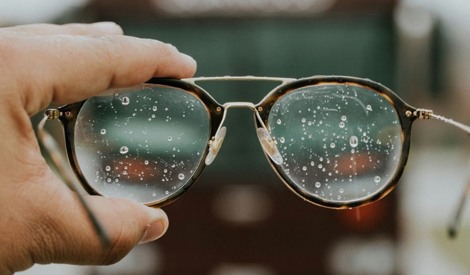 A person holds up glasses fogged by water. The UK government was told to keep a proposed ransomware payments ban clear in scope