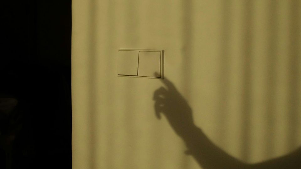 A shadow of someone's hand appears as if it is pressing a light switch. ChatGPT was knocked offline for 16 hours after an Ubuntu update in June