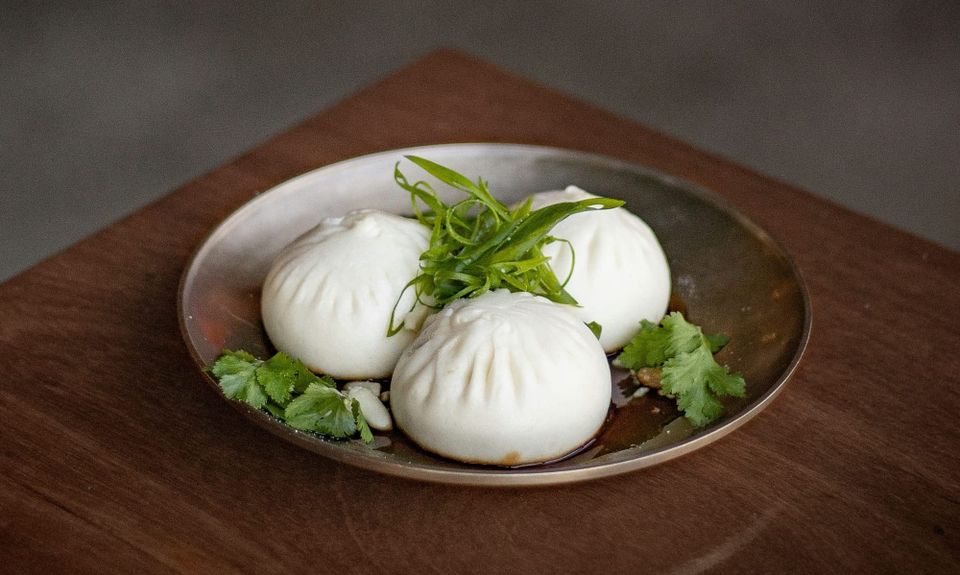 A plate of three bao buns. Anthropic has acquired open source project Bun