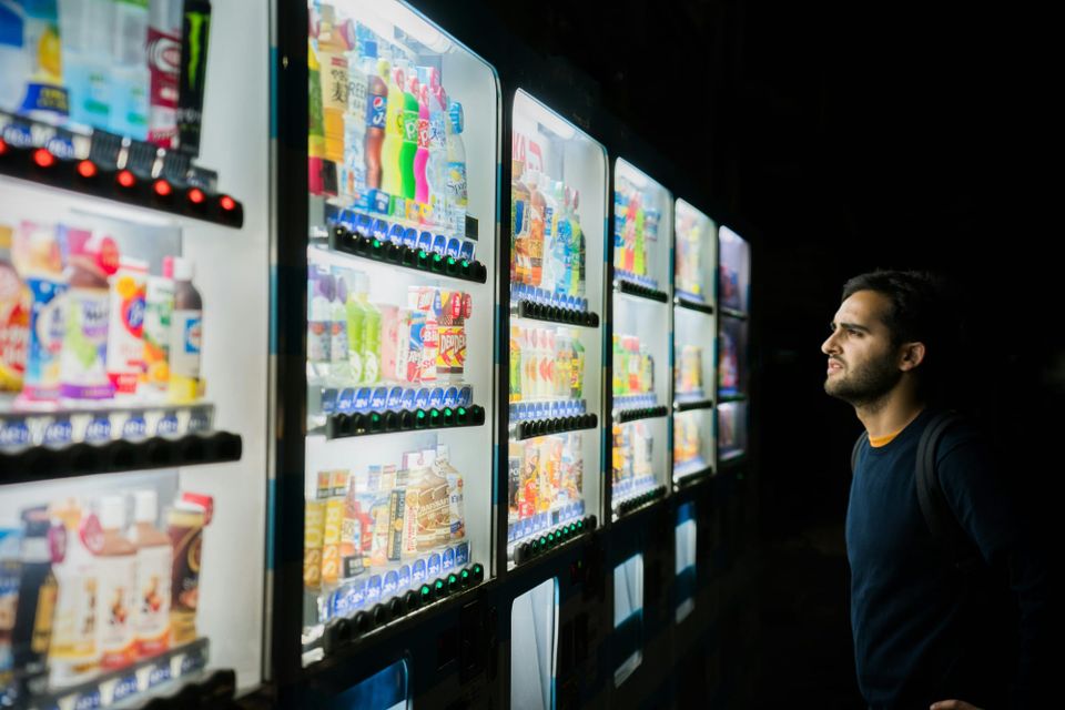 A man stands in front of a group of vending machines looking confused. European CIOs have multiple options on cloud sovereignty