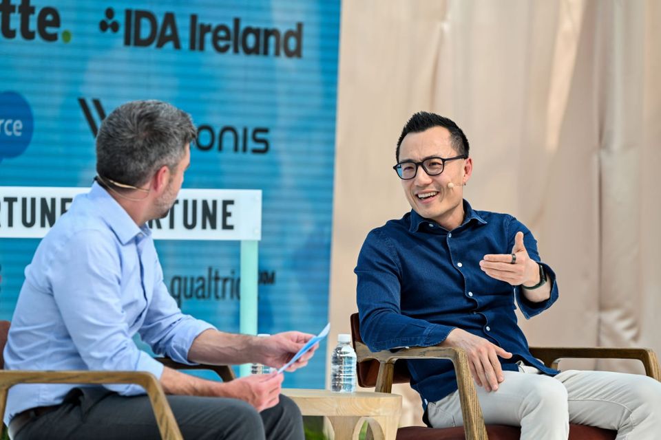 DoorDash CEO on stage in conversation with someon