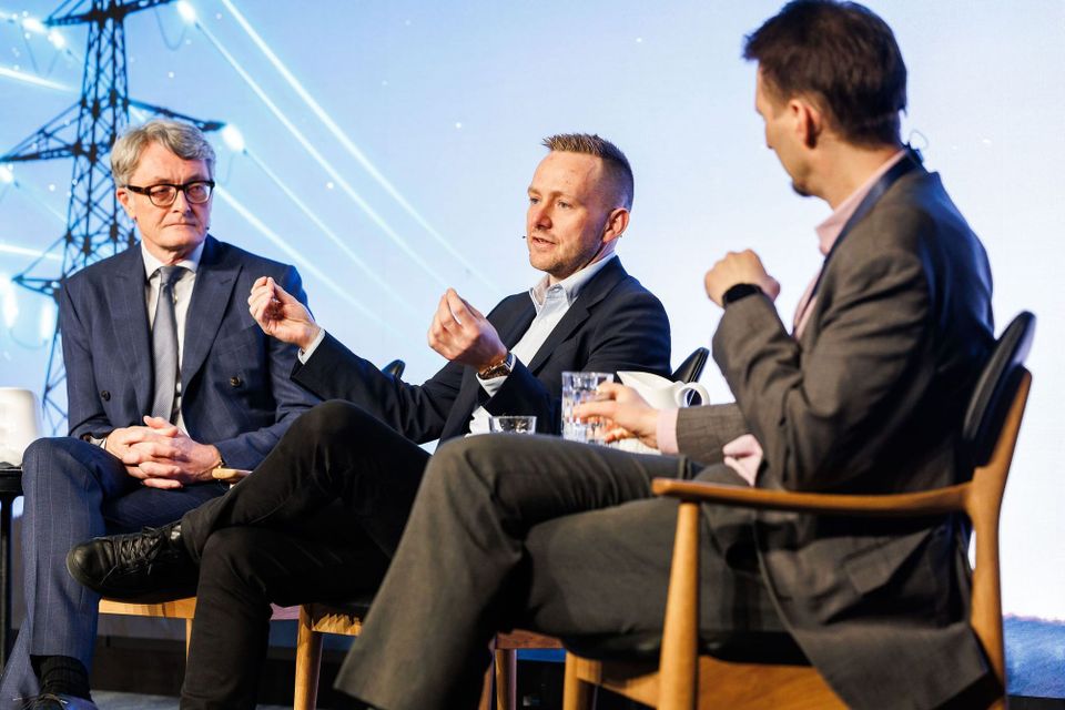 Nscale CEO Josh Payne sits on a stage as part of a conference panel.